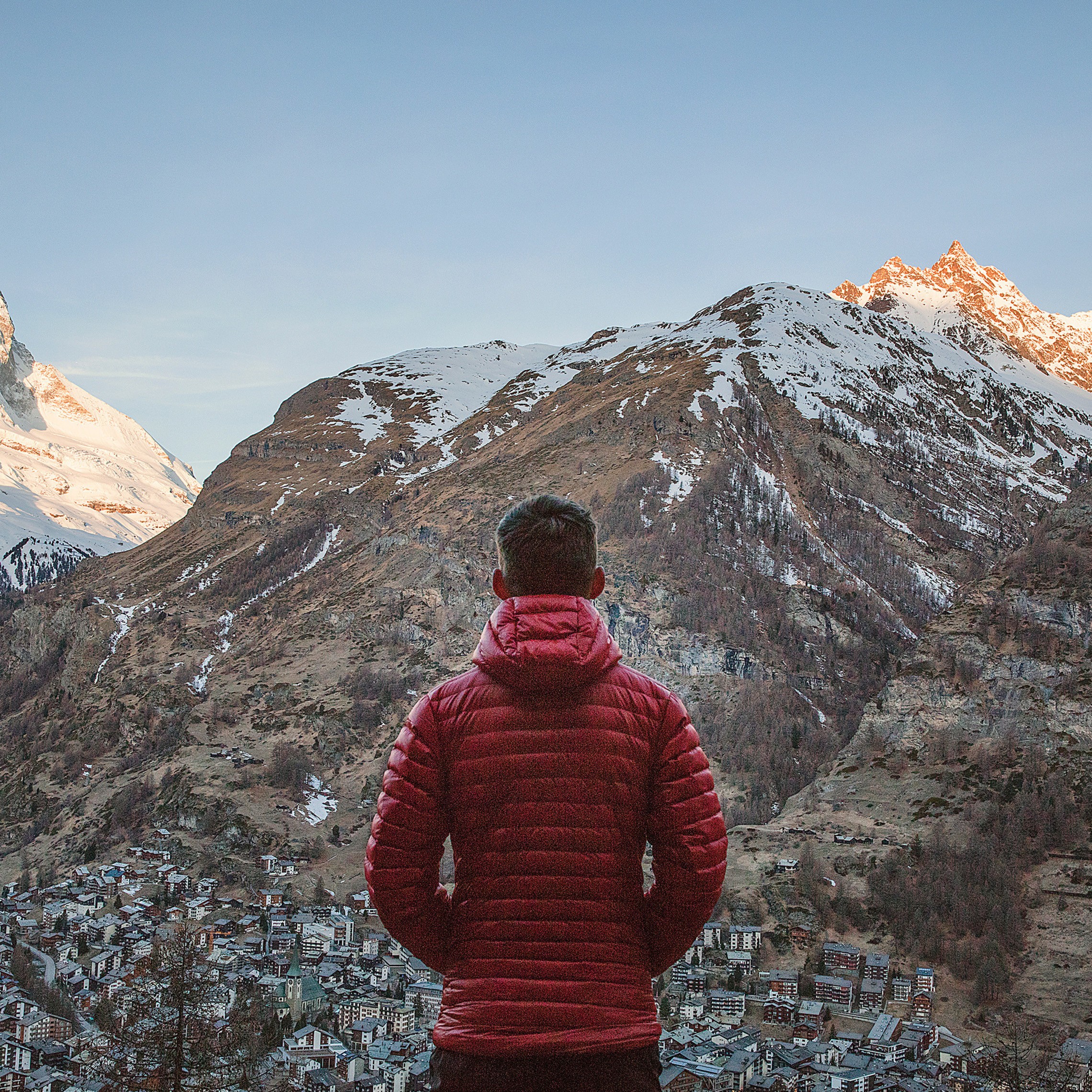 Man In Red Jacket Looking At The Alps In Zermatt Switzerland